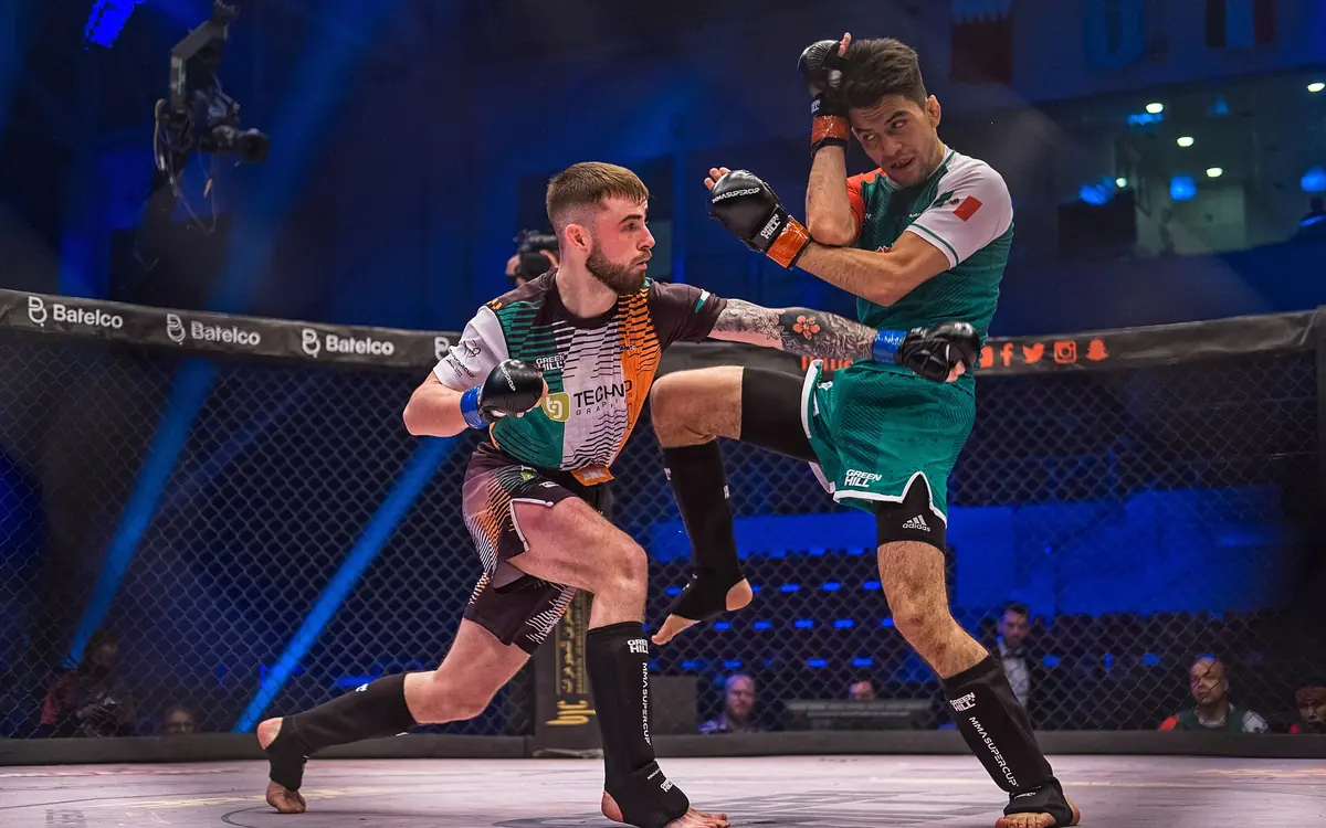Two fighters trading strikes inside the cage under arena lights